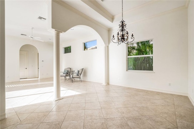 spare room featuring decorative columns, arched walkways, visible vents, and light tile patterned flooring