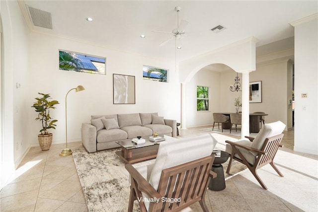 living area featuring visible vents, ornamental molding, recessed lighting, arched walkways, and light tile patterned floors