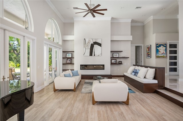 540 Marbrisa Dr, Vero Beach, FL 32963 - living room with visible vents, a towering ceiling, baseboards, built in features, and ceiling fan