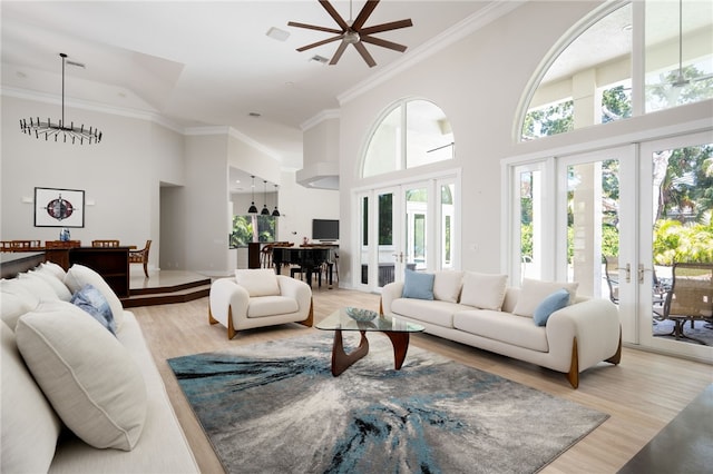 540 Marbrisa Dr, Vero Beach, FL 32963 - living room featuring light wood-type flooring, a high ceiling, ornamental molding, and french doors