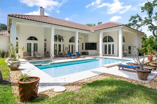 540 Marbrisa Dr, Vero Beach, FL 32963 - rear view of property with a chimney, an outdoor pool, a tiled roof, french doors, and a patio