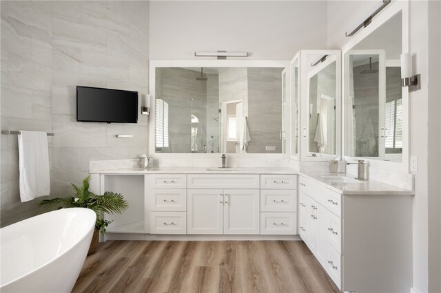 540 Marbrisa Dr, Vero Beach, FL 32963 - full bath featuring vanity, a stall shower, wood finished floors, and tile walls