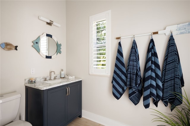 540 Marbrisa Dr, Vero Beach, FL 32963 - bathroom featuring plenty of natural light, baseboards, vanity, and toilet