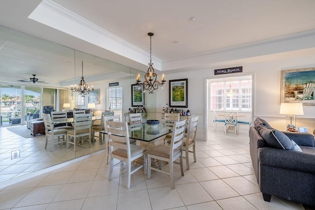 dining space featuring light tile patterned floors, a raised ceiling, a wealth of natural light, and ornamental molding