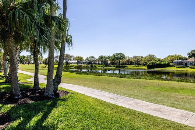 view of community with a yard and a water view