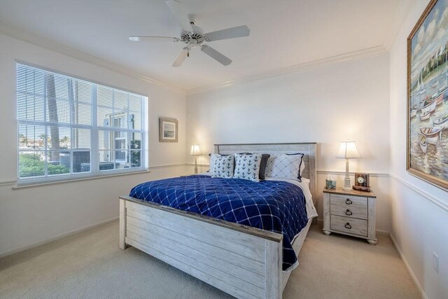 carpeted bedroom featuring ceiling fan, baseboards, and ornamental molding