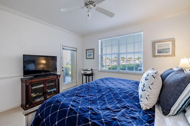 carpeted bedroom featuring crown molding, access to outside, a ceiling fan, and baseboards