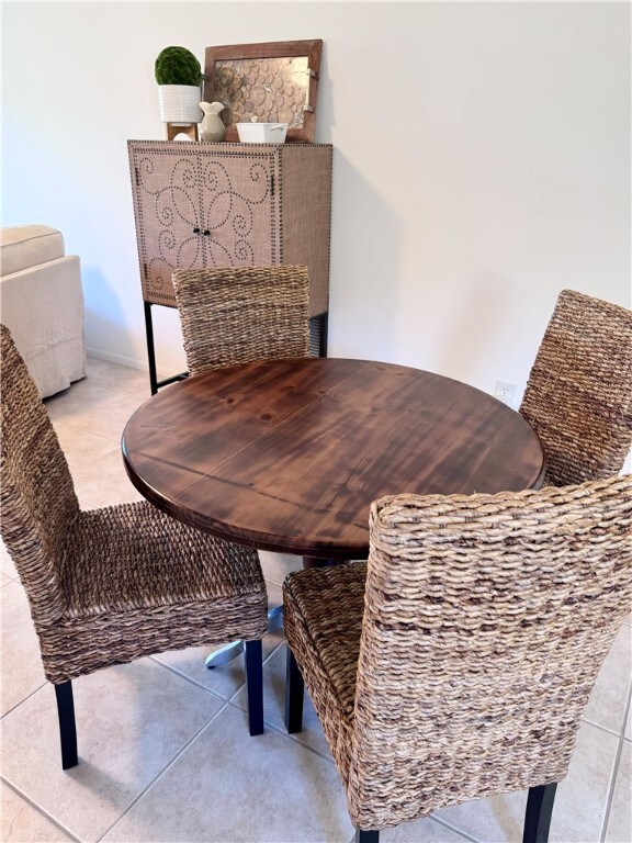 dining space featuring light tile patterned floors