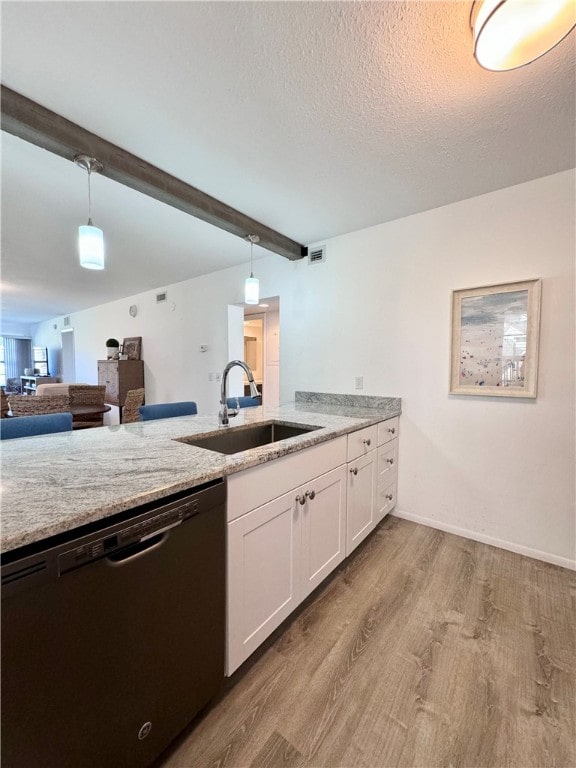 kitchen with light wood-type flooring, hanging light fixtures, sink, white cabinets, and dishwasher