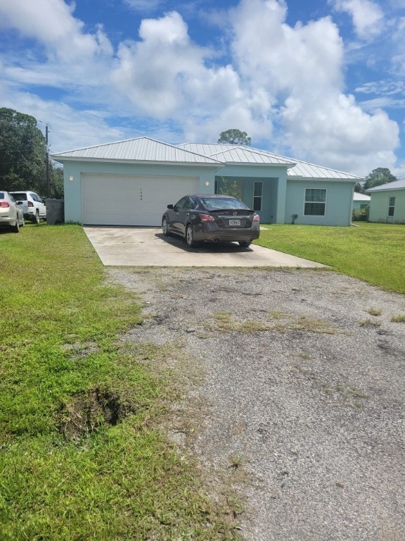 single story home featuring a front lawn and a garage