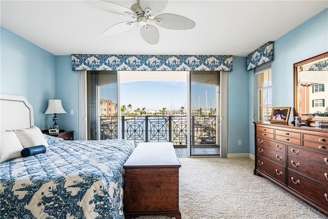 carpeted bedroom featuring access to exterior and ceiling fan