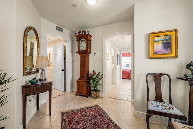 hall with light tile patterned flooring