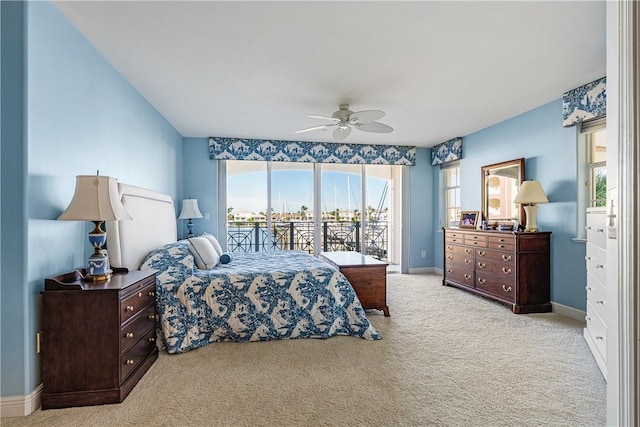 bedroom with access to exterior, ceiling fan, and light carpet