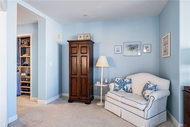 living area featuring light carpet