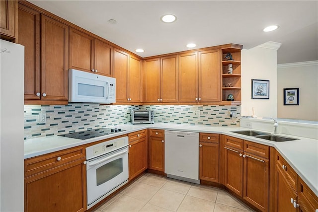 kitchen with tasteful backsplash, white appliances, crown molding, sink, and light tile patterned floors