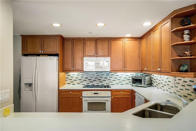 kitchen featuring decorative backsplash, white appliances, and sink