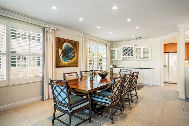 tiled dining room with ornamental molding