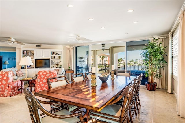 tiled dining room with a wealth of natural light and ceiling fan