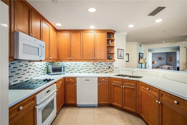 kitchen featuring backsplash, light tile patterned flooring, white appliances, and sink