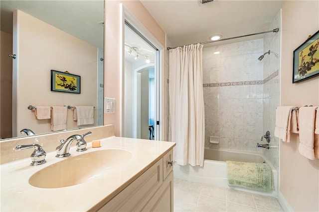 bathroom featuring tile patterned floors, vanity, and shower / tub combo with curtain