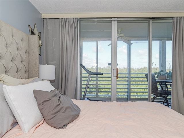 bedroom featuring a textured ceiling and access to outside