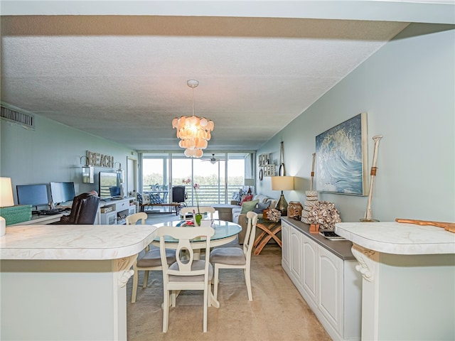 dining area featuring light colored carpet, a textured ceiling, and a notable chandelier