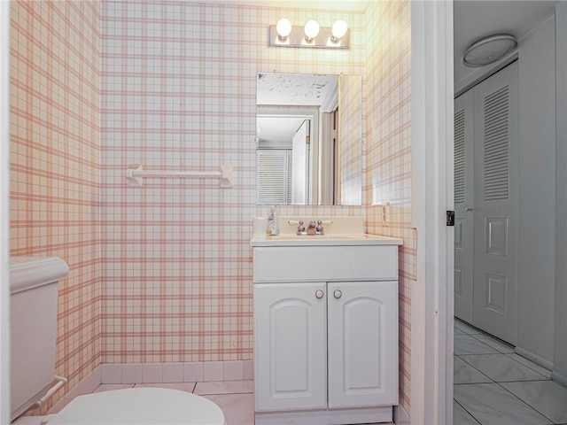 bathroom featuring toilet, vanity, and tile patterned floors