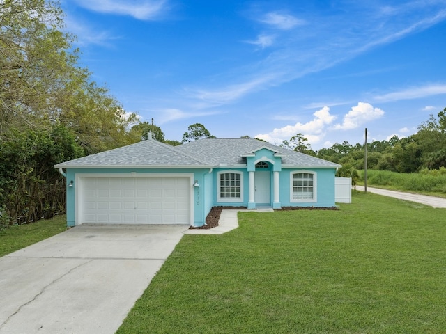 single story home featuring a garage and a front yard