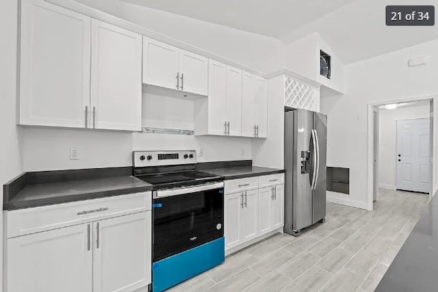 kitchen featuring range with electric cooktop, stainless steel fridge with ice dispenser, light hardwood / wood-style floors, lofted ceiling, and white cabinets