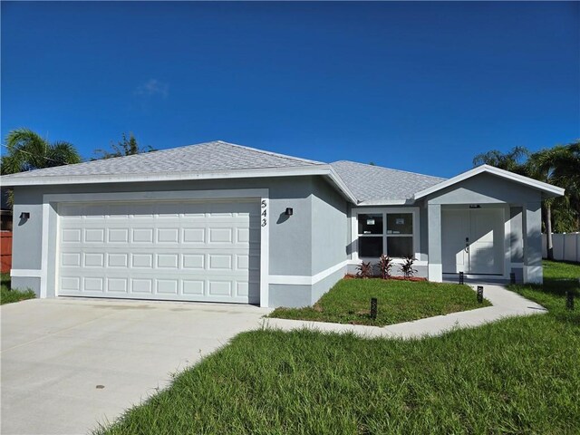 ranch-style home with a garage and a front yard