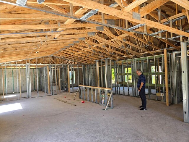 misc room with concrete floors and vaulted ceiling