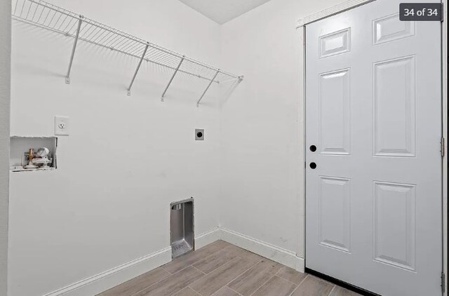 laundry area with electric dryer hookup, light hardwood / wood-style flooring, and washer hookup