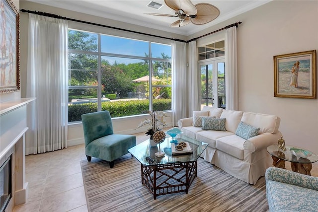 1300 Lake Bend Ct, Vero Beach, FL 32963 - living area with plenty of natural light, a ceiling fan, ornamental molding, and light tile patterned flooring