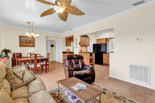 tiled living room with ceiling fan with notable chandelier and crown molding