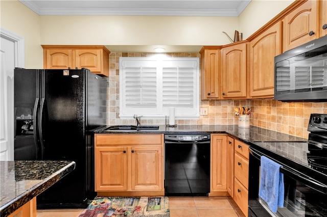 kitchen with black appliances, sink, dark stone counters, and light tile patterned flooring