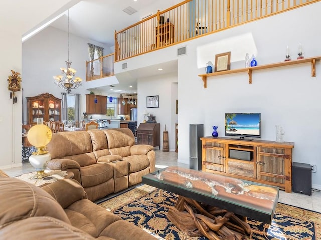 living room with tile patterned floors, a notable chandelier, and a towering ceiling