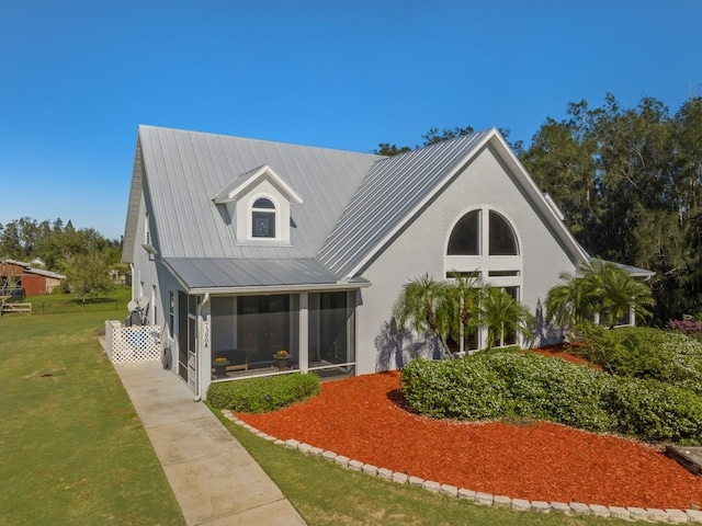 rear view of house featuring a yard