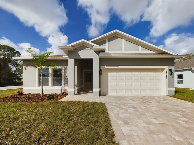 view of front of house with a garage and a front lawn