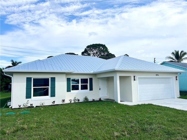 ranch-style home with metal roof, a front yard, an attached garage, and stucco siding