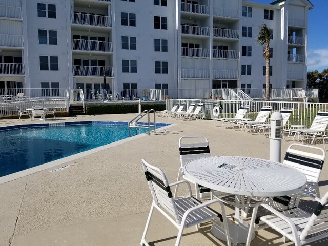 view of swimming pool featuring a patio area