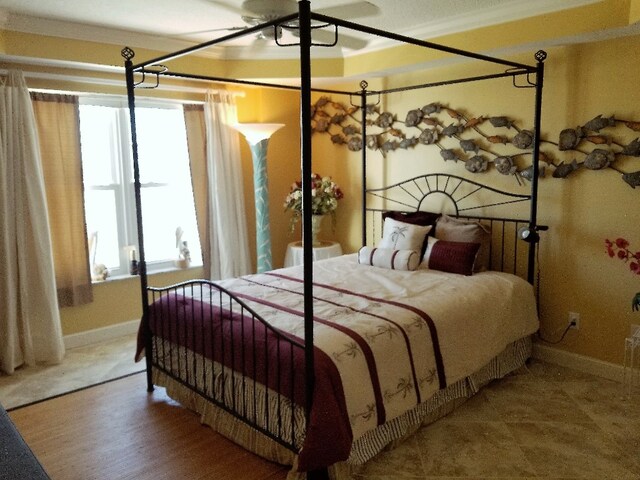 bedroom with ornamental molding and wood-type flooring