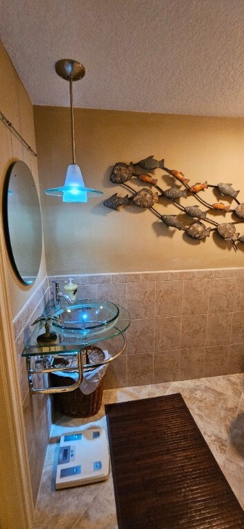 bathroom with sink, tile patterned flooring, and a textured ceiling