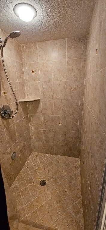 bathroom with a tile shower