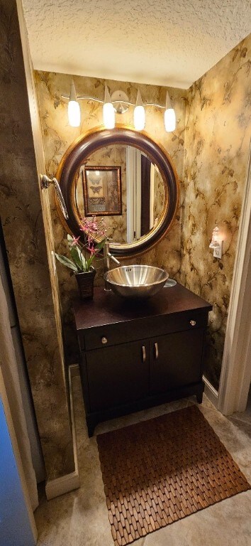 bathroom featuring vanity and a textured ceiling