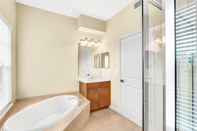 bathroom with vanity, tile patterned floors, and separate shower and tub