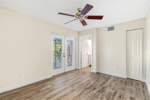 unfurnished bedroom with ceiling fan, access to exterior, french doors, a closet, and light wood-type flooring