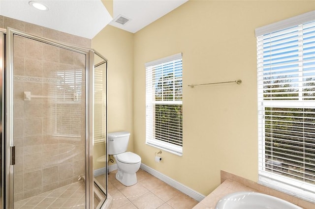 bathroom featuring tile patterned flooring, shower with separate bathtub, and toilet