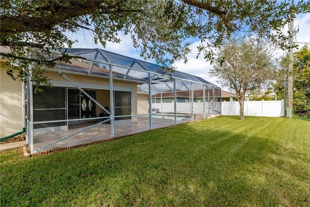 view of yard with a patio and glass enclosure