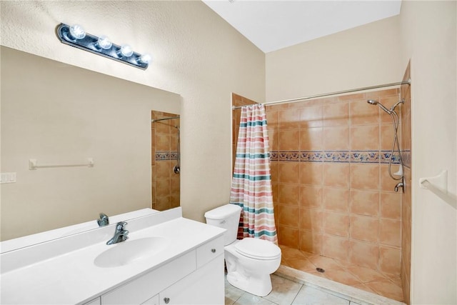 bathroom featuring toilet, vanity, a shower with curtain, and tile patterned floors