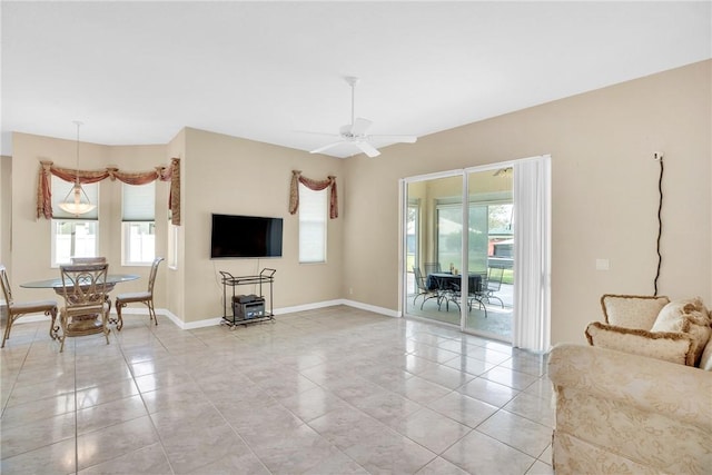 living room with ceiling fan and light tile patterned floors